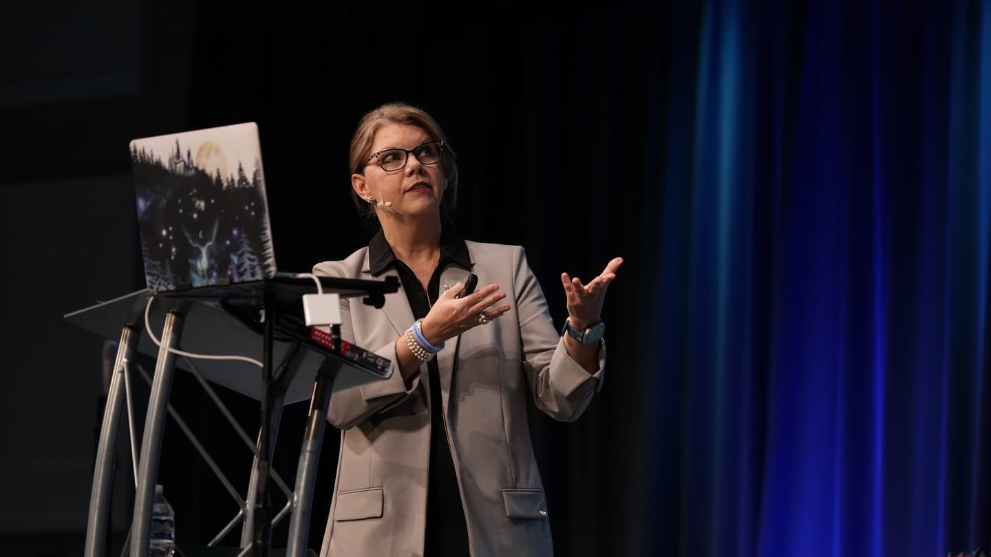Speaker addressing educators from a podium during a training event