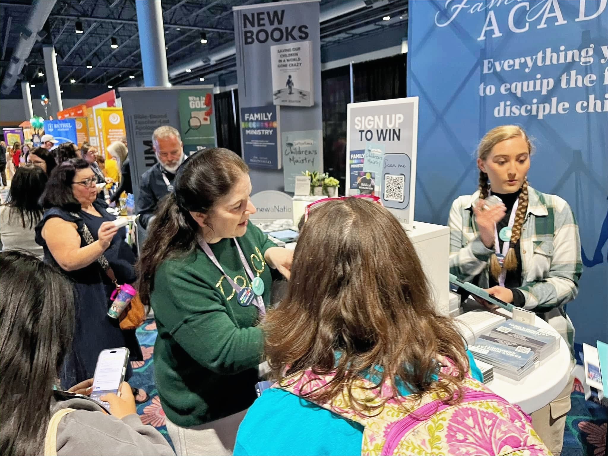 Visitors talking with staff at the RenewaNation conference booth