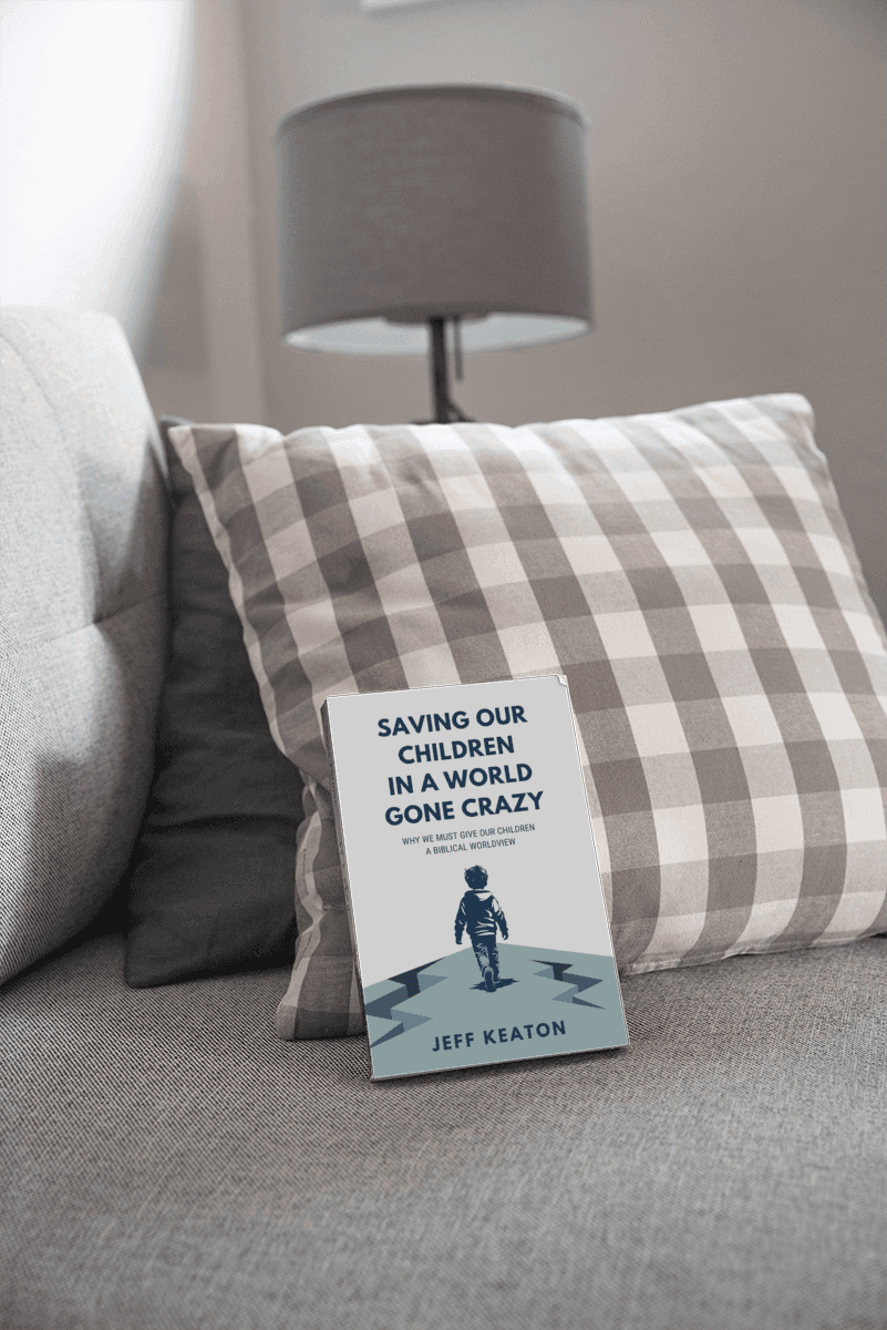 Saving Our Children in a World Gone Crazy by Jeff Keaton, propped against a plaid pillow