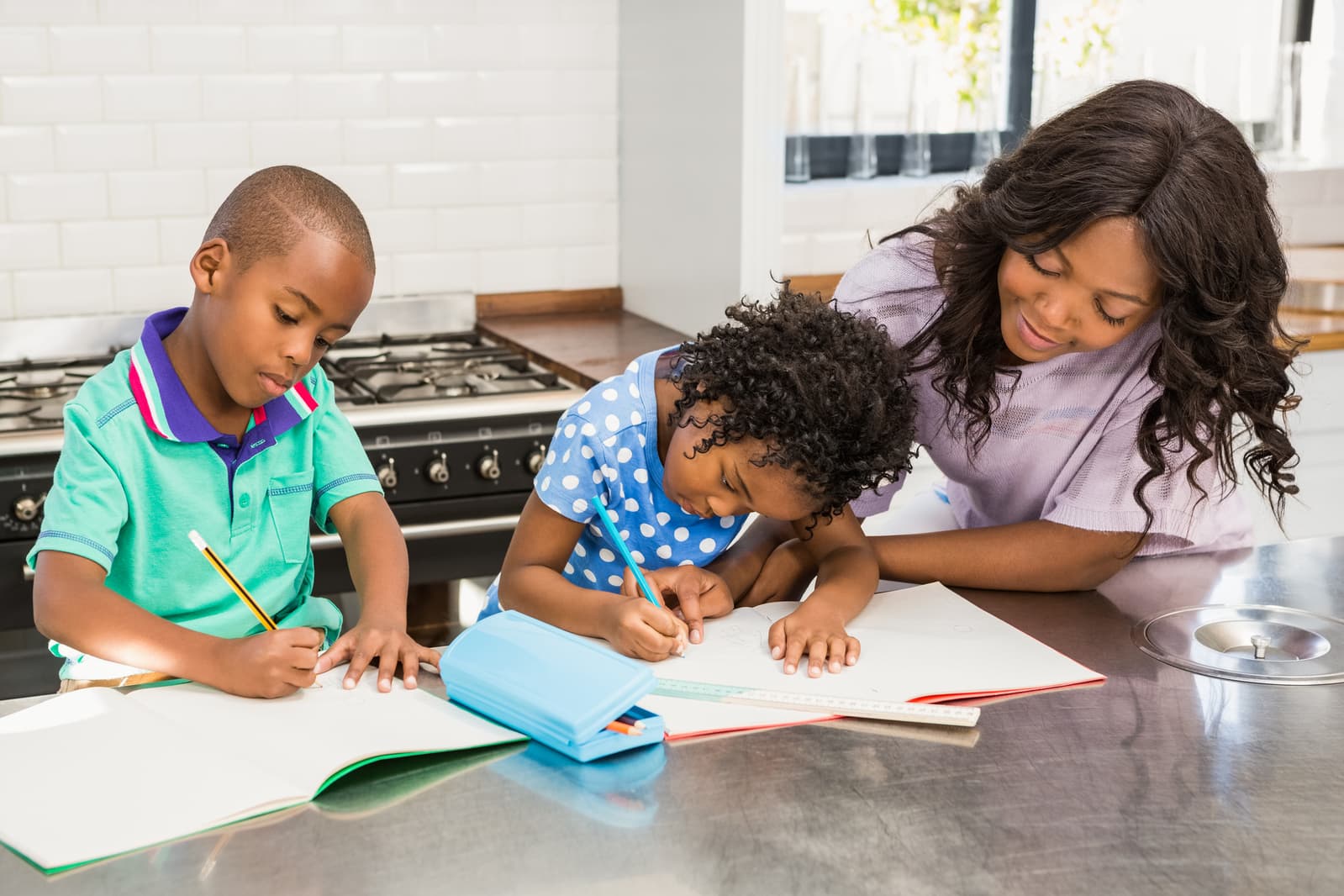 Parent homeschooling a child at the kitchen table